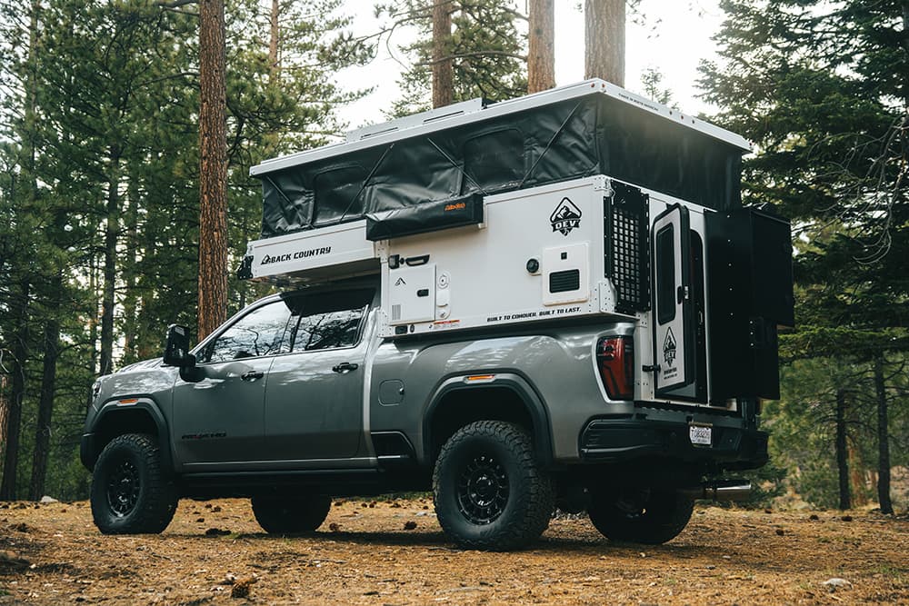Back Country 6.85’ slide-in truck camper, front three-quarter exterior view