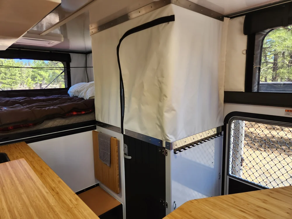 Hudson Bay 8 wet bath enclosure set up inside the pop-up beside the bed and galley