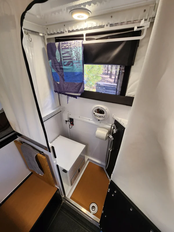 Inside the Hudson Bay 8 wet bath showing the toilet, shower, and floor drain